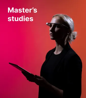 A KTU Faculty of Informatics student using a tablet and smart glasses against a red and pink decorative background. The faculty offers master’s studies. Choose KTU master’s studies.